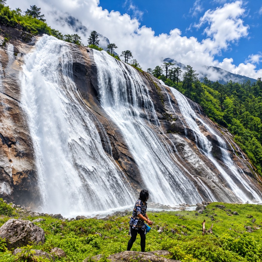 Pomo Waterfall surrounded by remote Himalayan forest and mountain scenery in Dibang Valley, Arunachal Pradesh